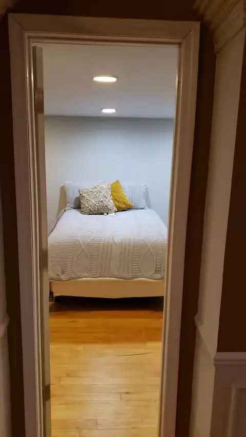 Bedroom framed by the original loft doorway